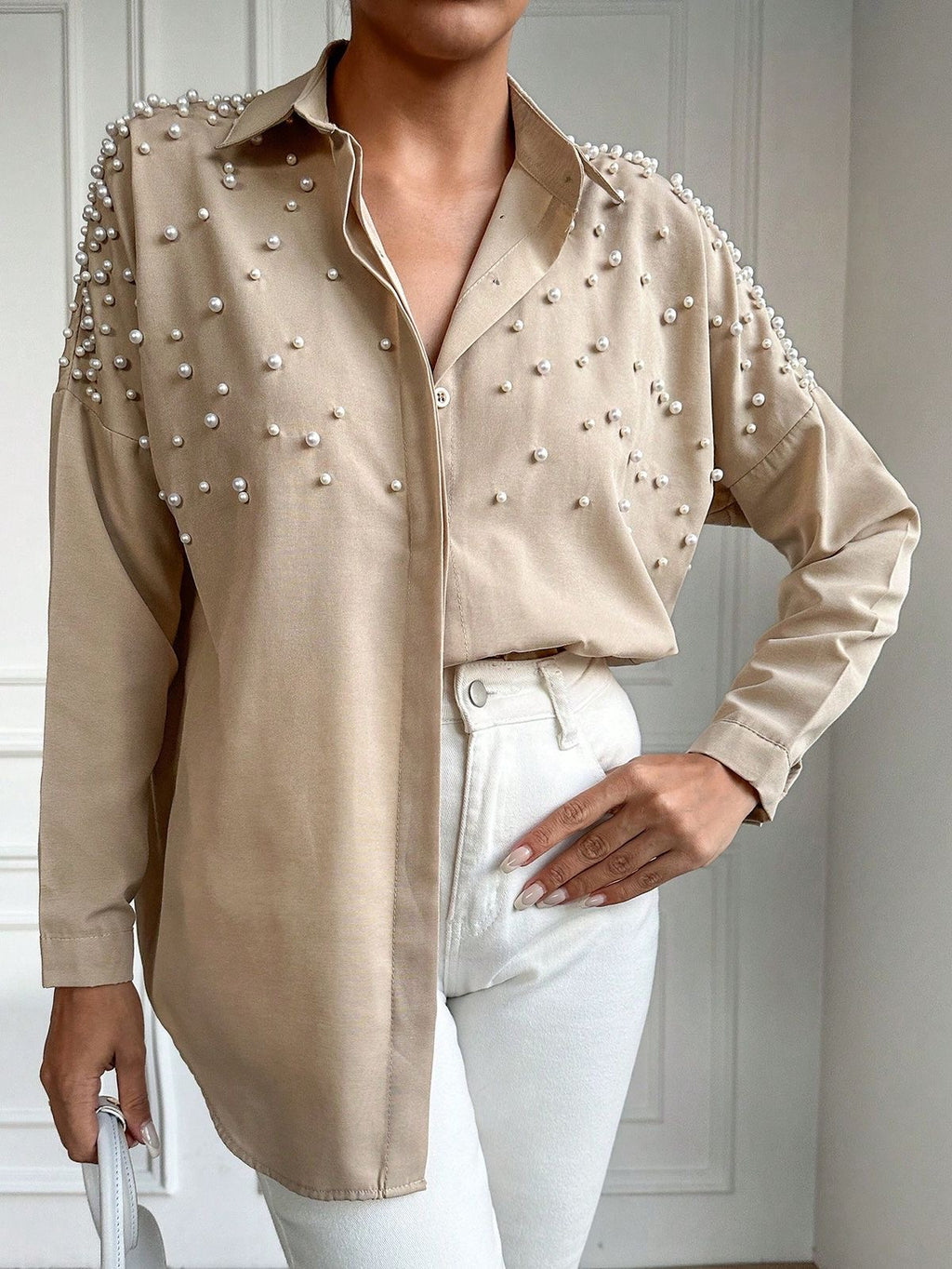 This pearl-detailed shirt brings effortless luxury to your everyday style.